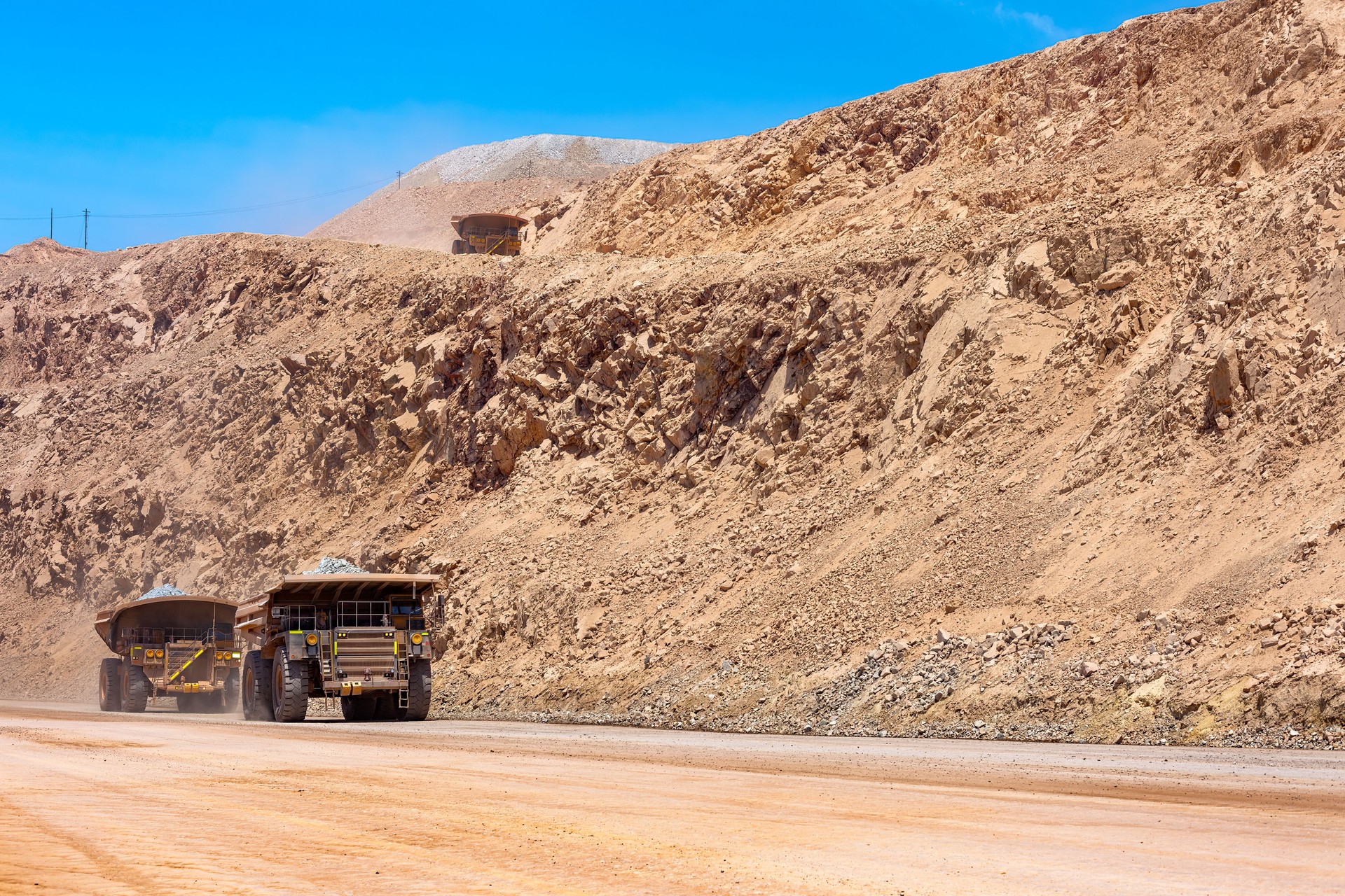 Huge large dump trucks at an open-pit copper mine in Peru.
