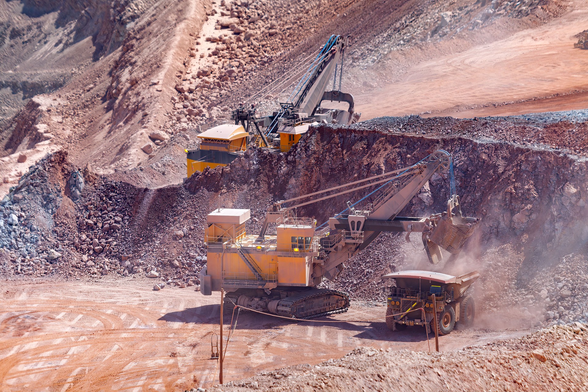 Electric rope shovel loading a dump truck at a copper mine in Peru